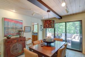 a dining room with a wooden table and chairs at Woodsy Mountain Home Escape Walk to Marina! in Mountain Home