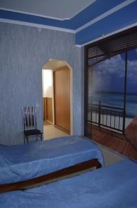 a bedroom with a bed and a view of the ocean at Private Residence Osobnyak in Odesa +122 photos