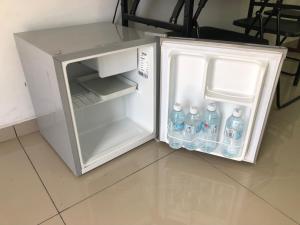 an open refrigerator with bottles of water in it at MKB Homestay in Shah Alam