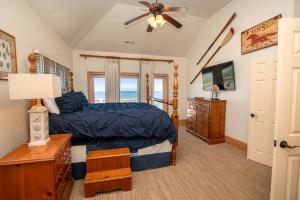 a bedroom with a bed and a ceiling fan at PI76, Life of Reilly- Oceanfront, Ocean Views, Private Pool, Private Beach Access, Foosball in Corolla