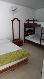 マリキタにあるHotel El Negroのベッド2台と二段ベッド2組が備わる客室です。