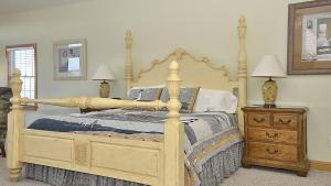 a bedroom with a large bed with a wooden frame at OCEANFRONT, Ocean Views, Priv Pool, Rec Room, 8 BRS, PM2, Old Glory in Sanderling +38 photos