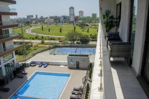 a balcony with a view of a swimming pool at A307 Luxury 1 Bedroom in Accra
