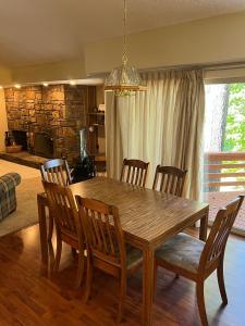 a dining room table with wooden chairs and a dining room at Trailside Vacation Home 7 in Bella Vista