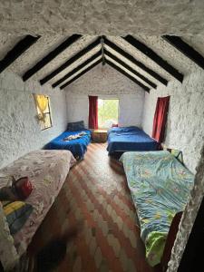a room with three beds and a window at FINCA VILLA DEL CARMEN in Sibaté