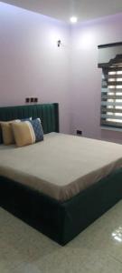 um quarto com uma cama grande num quarto em B8B Chessville Corte 3 em Abuja