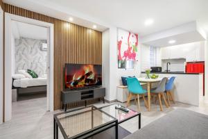 a living room with a fireplace and a table with chairs at ALCALA QUINTANA - 3 Bedrooms in Madrid