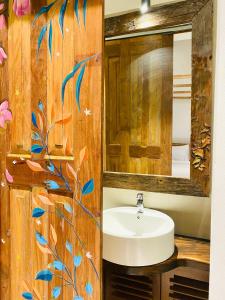 a bathroom with a sink and a mirror at Ivy Lane Galle Fort in Galle