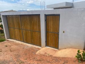 two doors on the side of a house at Casa Jardim Primavera in Cunha +3 photos