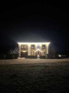 een huis verlicht in de nacht met lichten bij Opushka in Vorobʼyëvka