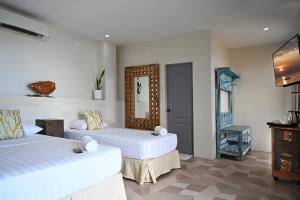 Ένα ή περισσότερα κρεβάτια σε δωμάτιο στο Oslob Whale Shark Resort
