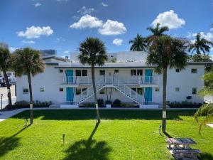 um edifício com palmeiras em frente em Rolo Beach Hotel em Fort Lauderdale