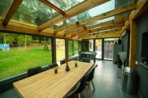 a dining room with a large wooden table with chairs at Casa Negra in Brestovac