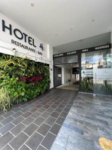 a hotel entrance with plants in a building at Hotel H53 in Sogamoso