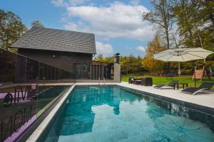 piscina con sedie e ombrellone di Casa Negra a Brestovac