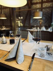 a table with wine glasses and napkins on it at Hotel Forsthaus in Winterberg