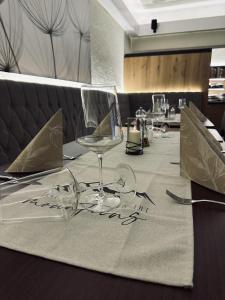 a table with a table cloth with glasses on it at Hotel Forsthaus in Winterberg