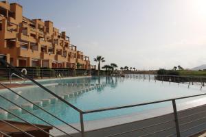 a large swimming pool next to some buildings at Las Terrazas De La Torre Golf Resort - Sueño De Los Hermanos in Roldán