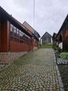 a cobblestone street in front of a building at Dubáčik Dovalovo in Liptovský Hrádok