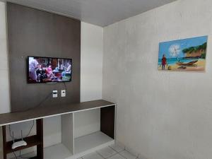 a room with a flat screen tv on a wall at Casa temporada Araçoiaba in Araçoiaba