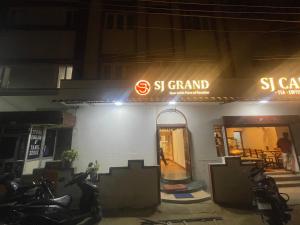 a store with motorcycles parked outside of it at night at SJ GRAND in Coimbatore