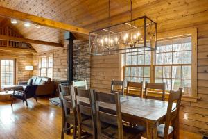 comedor con mesa de madera y sillas en Modern Log Cabin with Vineyard Views, en Penn Yan