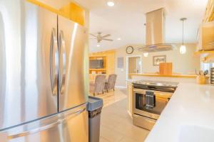 a large kitchen with a stainless steel refrigerator at The Chena River House South Suite in Fairbanks