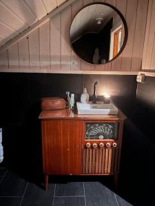 a bathroom with a sink and a mirror at Serviced Farmhouse - Kvaløyvågen Gård in Kvaløya
