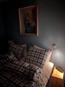 a bedroom with a bed and a painting on the wall at Serviced Farmhouse - Kvaløyvågen Gård in Kvaløya