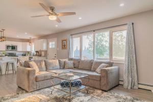 a living room with a couch and a table at Life is Better on the River in Fairbanks