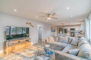 a living room with a couch and a ceiling fan at Life is Better on the River in Fairbanks