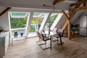 a kitchen and dining room with a glass table and chairs at DESIGN-Studio CHURCH 46 in Mülheim an der Ruhr