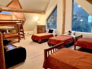 a bedroom with three beds and a large window at Hilltop Chalet-Stunning Views, 3mi from downtown in Prescott