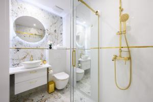 a bathroom with a shower and a toilet and a sink at Solaris Golden Blue in Darłowo