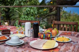 a table with cheese and other food on it at Villa Cordel in Fernando de Noronha