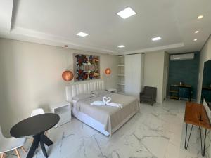 Villa'S Roraima - Pousada & Natureza في بوا فيستا: غرفة نوم بسرير وطاولة وكراسي