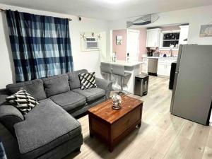 a living room with a couch and a table at Beachy Paradise in Clearwater Beach