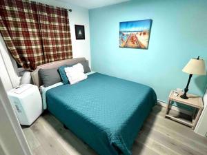 a small bedroom with a bed and a lamp at Beachy Paradise in Clearwater Beach