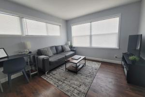 a living room with a couch and a table at Nice and cozy apartment in Ypsilanti