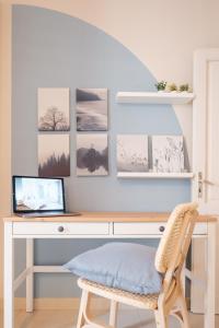 a desk with a laptop and a chair at Green Coast House 6 in Piombino +6 photos