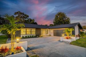 a house with a driveway and a garage at Cozy Clearwater Getaway Beach, Spa, and Luxury in Clearwater