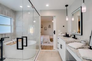 a bathroom with a shower and a sink and a tub at Cozy Clearwater Getaway Beach, Spa, and Luxury in Clearwater