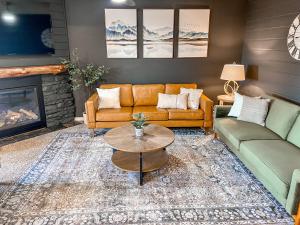 a living room with two couches and a fireplace at Remodeled Summit Condo at Snowshoe - Modern & Cozy in Snowshoe