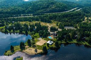 an aerial view of a house on an island in the water at Eagle's Nest in Saint-Faustin