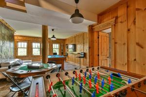 a living room with a pool table in a house at Eagle's Nest in Saint-Faustin