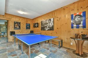 a ping pong table in a room with wooden walls at Eagle's Nest in Saint-Faustin