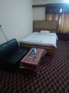 Taz Garden House في داكا: غرفة نوم بسرير وكرسي وطاولة