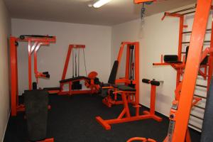 a gym with orange equipment in a room at Studio na horách in Cerny Dul