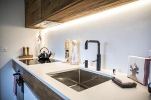 a kitchen with a sink and a counter top at Bergchalet Flöna in Scuol