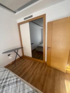 a bedroom with a mirror and a bed and a desk at FİNANSKENT SARPHAN RESİDANCE ATASEHİR in Istanbul